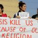Yazidi refugee women hold a banner as they wait for the arrival of United Nations High Commissioner for Refugees Special Envoy Angelina Jolie at a Syrian and Iraqi refugee camp in the southern Turkish town of Midyat in Mardin province, Turkey, on June 20, 2015. Photo courtesy of REUTERS/Umit Bektas