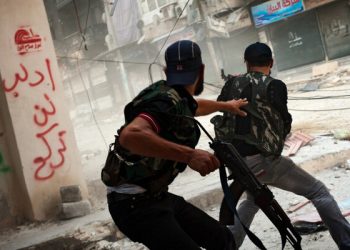 Free Syrian Army fighters exchange fire with regime forces in the Salah Al Din neighborhood of Aleppo, Aug. 22.