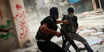 Free Syrian Army fighters exchange fire with regime forces in the Salah Al Din neighborhood of Aleppo, Aug. 22.