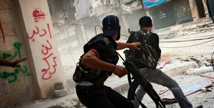 Free Syrian Army fighters exchange fire with regime forces in the Salah Al Din neighborhood of Aleppo, Aug. 22.