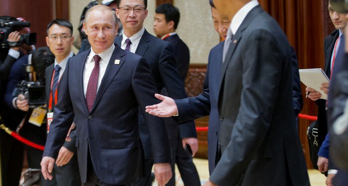 Russian President Vladimir Putin, left, Chinese President Xi Jinping, center, and U.S. President Barack Obama are seen arriving at the the Asia-Pacific Economic Cooperation (APEC) Summit plenary session at the International Convention Center, Yanqi, Tuesday, Nov. 11, 2014 in Beijing. (AP Photo/Pablo Martinez Monsivais, Pool)