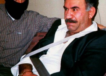 FILE - In this  Monday Feb. 15, 1999 file photo  provided by the Turkish Intelligence Service o the chief of the Kurdistan Workers Party, PKK, Abdullah Ocalan sits guarded aboard an aircraft en route to Turkey following his arrest by Turkish special forces in Nairobi, Kenya. Imprisoned Kurdish rebel leader Abdullah Ocalan said Monday, March 18, 2013 that peace talks with Turkey are making "positive progress" and that he plans to make a "historic" announcement to coincide with a Kurdish spring festival. (AP Photo/Turkish Intelligence Service, File)