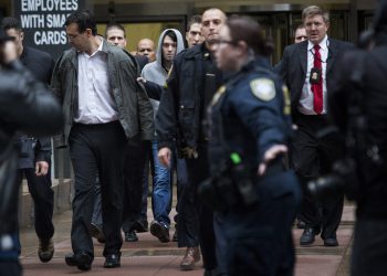 Martin Shkreli, chief executive officer of Turing Pharmaceuticals LLC, center, and attorney Evan Greebel, left, exit federal court in New York, U.S., on Thursday, Dec. 17, 2015. Shkreli was arrested on alleged securities fraud related to Retrophin Inc., a biotech firm he founded in 2011. Greebel is accused of conspiring with Shkreli in part of the scheme. Photographer: John Taggart/Bloomberg *** Local Caption *** Martin Shkreli; Evan Greebel