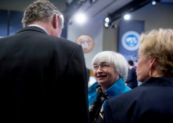 Janet Yellen, chair of the U.S. Federal Reserve, center, talks to Olivier Blanchard, chief economist of the International Monetary Fund (IMF), left, during the International Monetary Fund Committee (IMFC) governors plenary session at the International Monetary Committee (IMF) and World Bank Group Spring Meetings in Washington, D.C., U.S., on Saturday, April 18, 2015. IMF Managing Director Christine Lagarde warned this week that she wouldn't let Greece skip a debt payment to the lender, shutting down a potential avenue to buy the Greek government some financial leeway. Photographer: Andrew Harrer/Bloomberg via Getty Images
