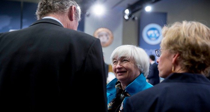 Janet Yellen, chair of the U.S. Federal Reserve, center, talks to Olivier Blanchard, chief economist of the International Monetary Fund (IMF), left, during the International Monetary Fund Committee (IMFC) governors plenary session at the International Monetary Committee (IMF) and World Bank Group Spring Meetings in Washington, D.C., U.S., on Saturday, April 18, 2015. IMF Managing Director Christine Lagarde warned this week that she wouldn't let Greece skip a debt payment to the lender, shutting down a potential avenue to buy the Greek government some financial leeway. Photographer: Andrew Harrer/Bloomberg via Getty Images