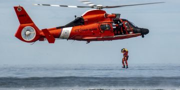 A Coast Guard rescue swimmer conducts a freefall direct deployment from an HH-65D Dolphin helicopter from Coast Guard Air Station Los Angeles, April 7, 2015. Coast Guard aviation survival technicians fill the role as rescue swimmers during flight operations and are responsible for all lifesaving equipment onboard the helicopter. (U.S. Coast Guard photograph by Petty Officer 1st Class Adam Eggers)