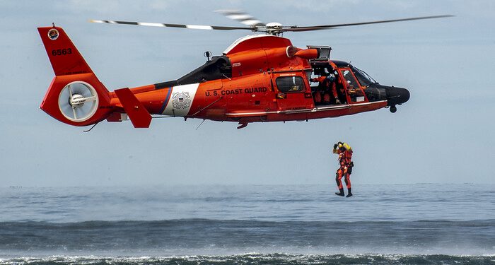 A Coast Guard rescue swimmer conducts a freefall direct deployment from an HH-65D Dolphin helicopter from Coast Guard Air Station Los Angeles, April 7, 2015. Coast Guard aviation survival technicians fill the role as rescue swimmers during flight operations and are responsible for all lifesaving equipment onboard the helicopter. (U.S. Coast Guard photograph by Petty Officer 1st Class Adam Eggers)