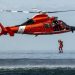 A Coast Guard rescue swimmer conducts a freefall direct deployment from an HH-65D Dolphin helicopter from Coast Guard Air Station Los Angeles, April 7, 2015. Coast Guard aviation survival technicians fill the role as rescue swimmers during flight operations and are responsible for all lifesaving equipment onboard the helicopter. (U.S. Coast Guard photograph by Petty Officer 1st Class Adam Eggers)