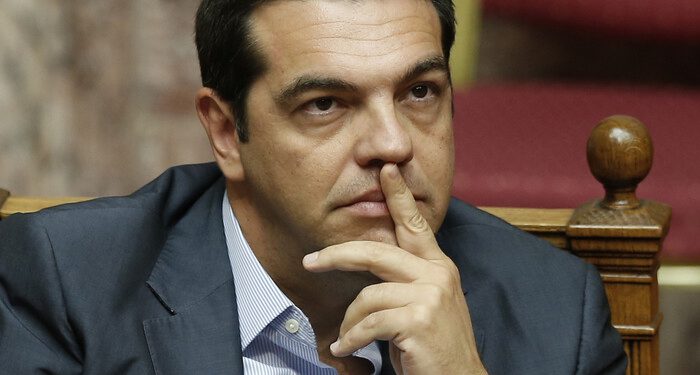 Greek Prime Minister Alexis Tsipras attends a parliamentary session in Athens, Friday, Aug. 14, 2015. Greek lawmakers are continuing a debate in parliament to approve a massive new bailout deal after repeated delays over procedure and dissent within the governing left-wing Syriza party caused the session to last through the night. (AP Photo/Yannis Liakos)