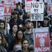 People hold signs as they listen to speakers at a protest against the election of President-elect Donald Trump, Wednesday, Nov. 9, 2016, in downtown Seattle. (AP Photo/Ted S. Warren)