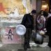 Activists of a  soup kitchen deliver food to an immigrant family in a poor neighborhood in Athens, on February 6, 2012. Greece today began constructing a fence on its border with Turkey to keep out thousands of undocumented migrants and refugees seeking to cross into Europe, the country's police minister said.  AFP PHOTO / LOUISA GOULIAMAKI