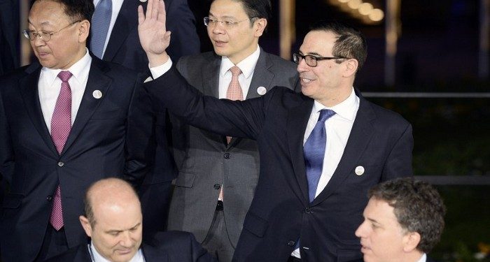 US Secretary of the Treasury Steven Mnuchin (R) waves as he and other participants in the G20 Finance Ministers and Central Bank Governors Meeting pose for the Family photo in Baden-Baden, southern Germany, on March 17, 2017.       
Finance ministers from the world's top nations gather in Germany on March 17, as fears grow of a looming trade war over US President Donald Trump's America First policy. / AFP PHOTO / Thomas Kienzle