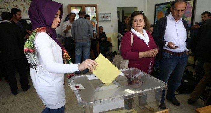 A Turkish woman casts her ballot as she votes in Turkey's general election at a polling station  in a primary school in Ankara on June 7, 2015. Turkey Turkish voters went to the polls on June 7 in a bitterly-contested election set to determine whether President Recep Tayyip Erdogan can tighten his increasingly controversial grip on the country. The legislative election is taking place under the shadow of violence after two people were killed and dozens more wounded in an attack on a rally of the pro-Kurdish People's Democratic Party (HDP) in the southeastern city of Diyarbakir two days prior. AFP PHOTO / ADEM ALTAN