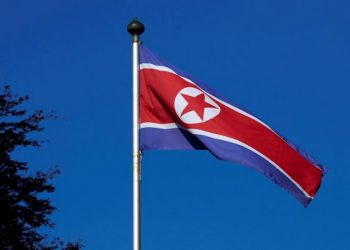 FILE PHOTO - A North Korean flag flies on a mast at the Permanent Mission of North Korea in Geneva October 2, 2014. REUTERS/Denis Balibouse/File Photo