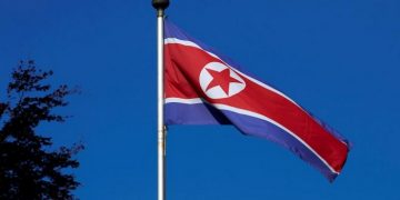 FILE PHOTO - A North Korean flag flies on a mast at the Permanent Mission of North Korea in Geneva October 2, 2014. REUTERS/Denis Balibouse/File Photo