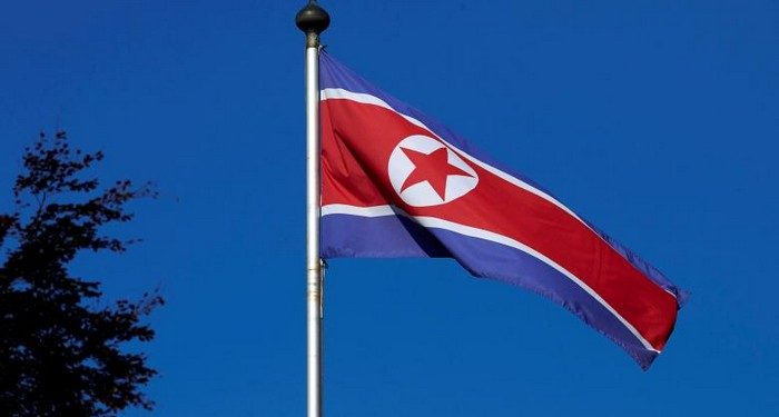 FILE PHOTO - A North Korean flag flies on a mast at the Permanent Mission of North Korea in Geneva October 2, 2014. REUTERS/Denis Balibouse/File Photo