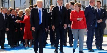 (L-R) U.S. President Donald Trump, NATO Secretary General Jens Stoltenberg and German Chancellor Angela Merkel gather with NATO member leaders to pose for a family picture before the start of their summit in Brussels, Belgium, May 25, 2017.REUTERS/Jonathan Ernst