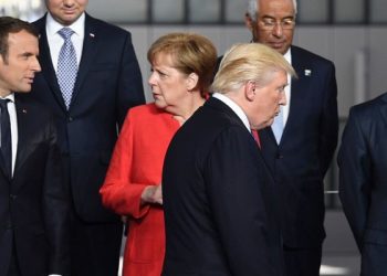 French President Emmanuel Macron (L) and German Chancellor Angela Merkel (2nd L) speaks as US President Donald Trump (C) arrives next to Greek Prime Minister Alexis Tsipras (R) for a family picture during the NATO (North Atlantic Treaty Organization) summit at the NATO headquarters, in Brussels, on May 25, 2017. / AFP PHOTO / Eric FEFERBERG        (Photo credit should read ERIC FEFERBERG/AFP/Getty Images)