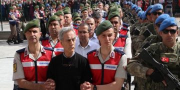 Turkish Gendarmerie escort defendants Akin Ozturk (2L) and others involved in last Julys attempted coup in Turkey as they leave the prison where they are being held, ahead of their trial in Ankara, on May 22, 2017.
The trial opened on May 22, 2017 of more than 220 suspects, including over two dozen former Turkish generals, accused of being among the ringleaders of the attempted coup last year aimed at ousting President Recep Tayyip Erdogan. / AFP PHOTO / ADEM ALTAN        (Photo credit should read ADEM ALTAN/AFP/Getty Images)