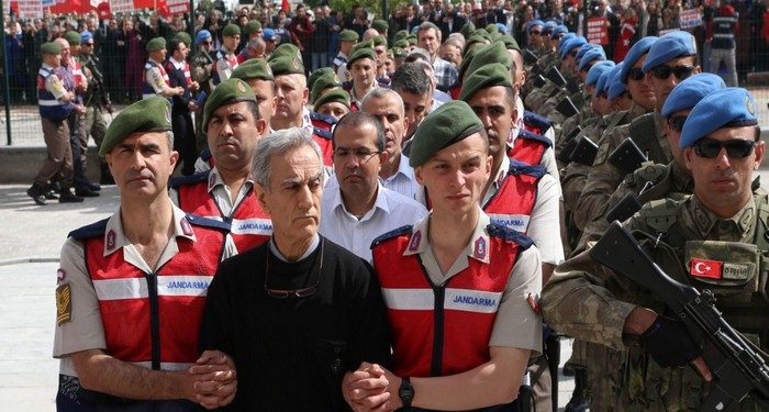 Turkish Gendarmerie escort defendants Akin Ozturk (2L) and others involved in last Julys attempted coup in Turkey as they leave the prison where they are being held, ahead of their trial in Ankara, on May 22, 2017.
The trial opened on May 22, 2017 of more than 220 suspects, including over two dozen former Turkish generals, accused of being among the ringleaders of the attempted coup last year aimed at ousting President Recep Tayyip Erdogan. / AFP PHOTO / ADEM ALTAN        (Photo credit should read ADEM ALTAN/AFP/Getty Images)