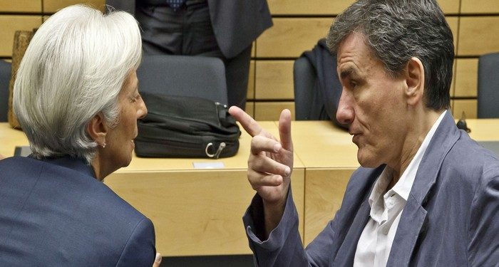 Greek Finance Minister Euclid Tsakalotos, right, speaks with Managing Director of the International Monetary Fund Christine Lagarde during a round table meeting of eurogroup finance ministers at the EU Lex building in Brussels on Sunday, July 12, 2015. Greece has another chance Sunday to convince skeptical European creditors that it can be trusted to enact wide-ranging economic reforms which would safeguard its future in the common euro currency. (AP Photo/Michel Euler)