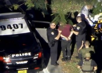 A man placed in handcuffs is led by police near Marjory Stoneman Douglas High School following a shooting incident in Parkland, Florida, U.S. February 14, 2018 in a still image from video.  WSVN.com via REUTERS. ATTENTION EDITORS - THIS IMAGES HAS BEEN PROVIDED BY A THIRD PARTY. NO RESALES, NO ARCHIVES. MANDATORY CREDIT. NO ACCESS SOUTHEAST FLORIDA MEDIA.