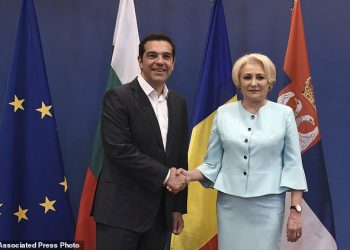 Greek Prime Minister Alexis Tsipras, left, shakes hands with his Romanian counterpart Viorica Dancila, during a meeting of the heads of government of Greece, Bulgaria, Romania and Serbia, at the northern port city of Thessaloniki , Greece, on Wednesday, July 4, 2018. (AP Photo/Giannis Papanikos)