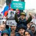 People with posters show portraits of detained protesters and a boy with a poster reads Lyubov Sobol react during a protest in Moscow, Russia, Saturday, Aug. 10, 2019. Tens of thousands of people rallied in central Moscow for the third consecutive weekend to protest the exclusion of opposition and independent candidates from the Russian capital's city council ballot. (AP Photo/Alexander Zemlianichenko)