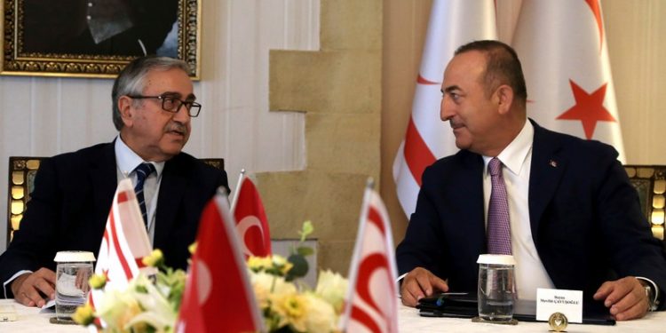 Turkish Foreign Minister Mevlut Cavusoglu, right, talks with Turkish Cypriot leader Mustafa Akinci during a meeting in the Turkish occupied area in the northern part of divided capital Nicosia, Cyprus, Monday, Sept. 9, 2019. Cavusoglu is in the northern part of divided Cyprus for three-day visit. (AP Photo/Petros Karadjias)
