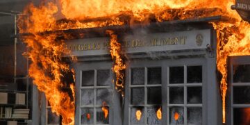 A Los Angeles Police Department kiosk is seen ablaze in The Grove shopping center during a protest over the death of George Floyd, Saturday, May 30, 2020, in Los Angeles. Protests were held in U.S. cities over the death of Floyd, a black man who died after being restrained by Minneapolis police officers on May 25.  (AP Photo/Mark J. Terrill)
