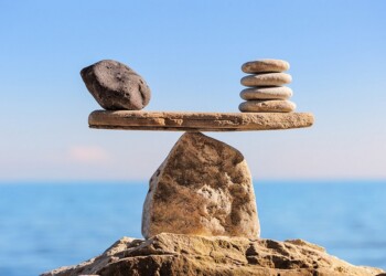 Symbol of scales is made of stones on the boulder
