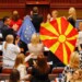 North Macedonian members of Parliament from the ruling SDSM party, hold European Union and North Macedonian flags, during a parliamentary debate on a French-brokered deal aimed at settling disputes with Bulgaria and clearing the way to EU membership, in Skopje, North Macedonia, July 16, 2022. REUTERS/Ognen Teofilovski