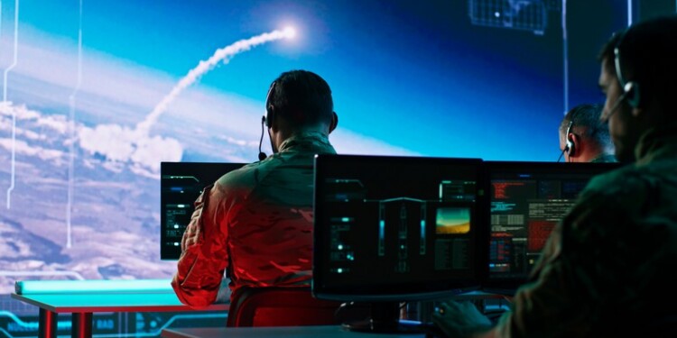 Zoom in view of military men using computers to watch online broadcast and launch nuclear missile during work in control center during world war