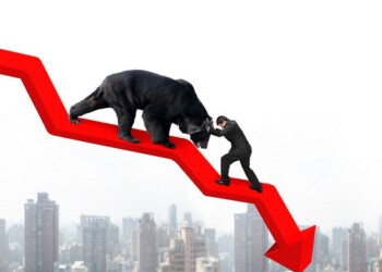 Businessman against black bear on red arrow downward trend line with sky cityscape background. Fight back bearish market concept.