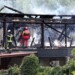 Firefighters inspect a burnt building after a fire erupted at a holiday home for disabled people in Wintzenheim, eastern France, on August 9, 2023. Authorities found nine corpses after a fire ravaged a centre housing holidaying adults with learning difficulties in eastern France, the fire brigade said. (Photo by Sebastien BOZON / AFP)