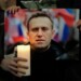 Protesters hold a picture of Alexei Navalny as they stage a demonstration opposite the Russian Embassy in London, Friday, Feb. 16, 2024, in reaction to the news that jailed Russian opposition leader Alexei Navalny has died in a Russian prison, according to the Federal Penitentiary Service. (AP Photo/Kin Cheung)