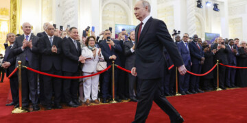 In this pool photograph distributed by Russian state agency Sputnik, Russian president-elect Vladimir Putin walks prior to his inauguration ceremony at the Kremlin in Moscow on May 7, 2024. (Photo by Artem Geodakyan / POOL / AFP)