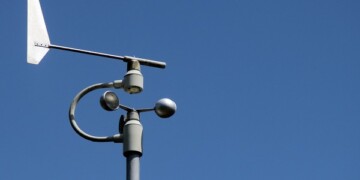 Weather station instruments against blue sky background