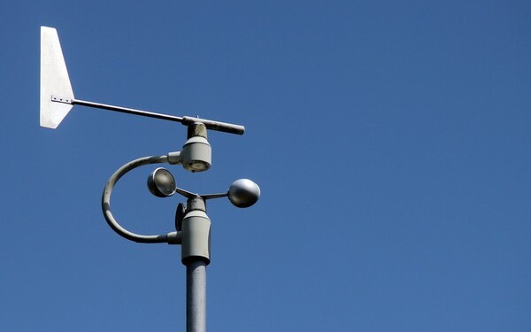 Weather station instruments against blue sky background