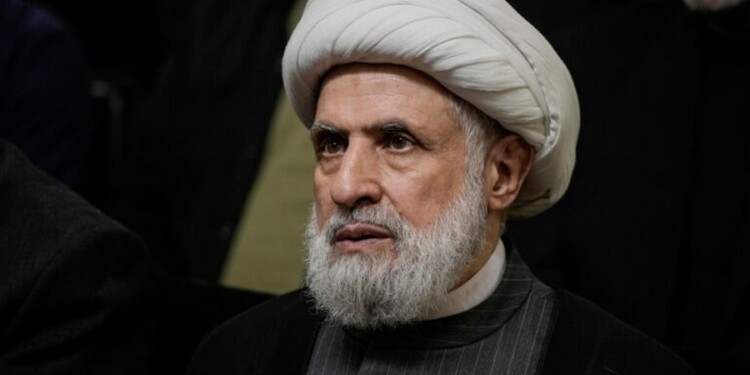 FILE - Hezbollah's deputy leader, Sheikh Naim Kassem, listens to a speech by then-leader Hassan Nasrallah on a screen in southern Beirut, Wednesday, June 19, 2024. (AP Photo/Bilal Hussein, File)