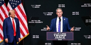 Republican presidential nominee former President Donald Trump, left, listens as investor Scott Bessent speaks on the economy in Asheville, N.C., Wednesday, Aug. 14, 2024. (AP Photo/Matt Kelley)