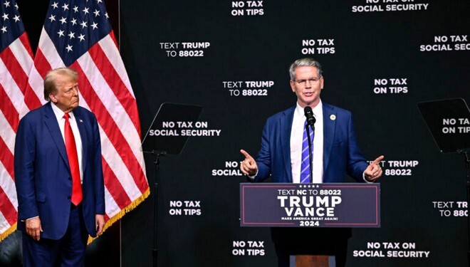 Republican presidential nominee former President Donald Trump, left, listens as investor Scott Bessent speaks on the economy in Asheville, N.C., Wednesday, Aug. 14, 2024. (AP Photo/Matt Kelley)