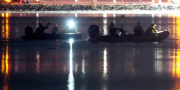 Boats work the scene in the Potomac River near Ronald Reagan Washington National Airport, Thursday, Jan. 30, 2025, in Arlington, Va. (AP Photo/Alex Brandon)