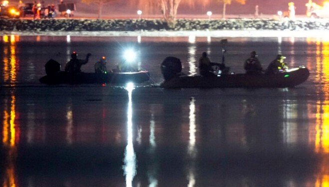 Boats work the scene in the Potomac River near Ronald Reagan Washington National Airport, Thursday, Jan. 30, 2025, in Arlington, Va. (AP Photo/Alex Brandon)