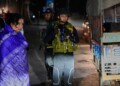 An Indian army officer stands guard as tourists look on at a temporary checkpoint near Pahalgam in south Kashmir after assailants indiscriminately opened fire on tourists visiting Pahalgam, Indian controlled Kashmir, Tuesday, April 22, 2025. (AP Photo/Dar Yasin)