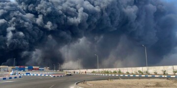 In this photo provided by Iranian Students' News Agency, ISNA, a black smoke rises in the sky after a massive explosion rocked a port near the southern port city of Bandar Abbas, Iran, Saturday, April 26, 2025. (Razieh Pudat/ISNA via AP)
