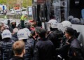 A union member shouts slogans as he is detained by Turkish police officers during Labor Day celebrations in Istanbul, Turkey, Thursday, May 1, 2025. (AP Photo/Khalil Hamra)
