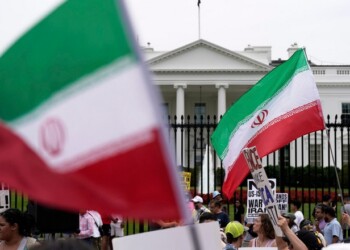 Demonstrators carry signs and wave the Iranian flag as they rally outside the White House, Sunday, June 22, 2025, in Washington, to protest the U.S. military strike on three sites in Iran early Sunday. (AP Photo/Jose Luis Magana)