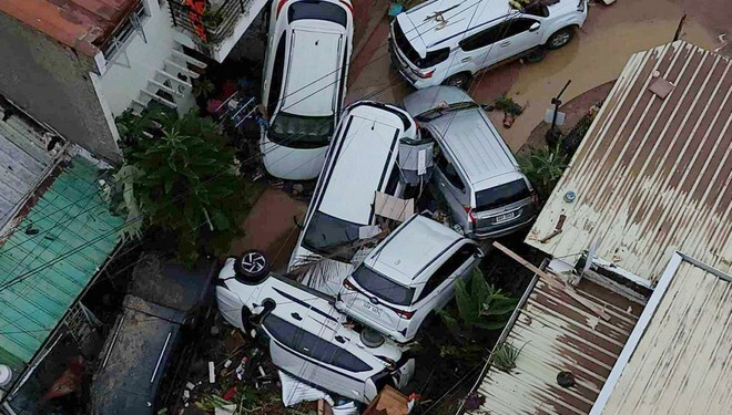 Cars are piled on top of each other after flooding caused by Typhoon Kalmaegi in Cebu city, central Philippines, Tuesday, Nov. 4, 2025. (AP Photo/Jacqueline Hernandez)