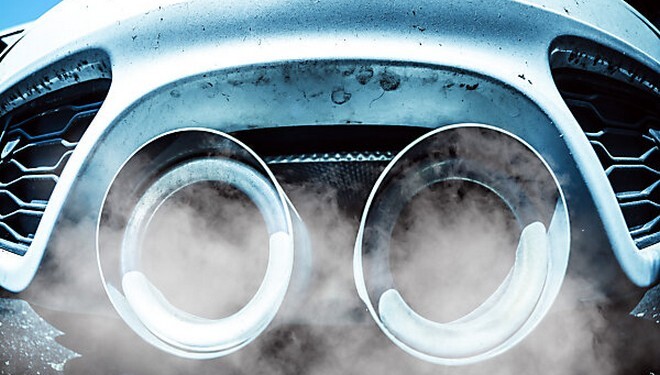 Smoking exhaust pipes of a car with combustion engine